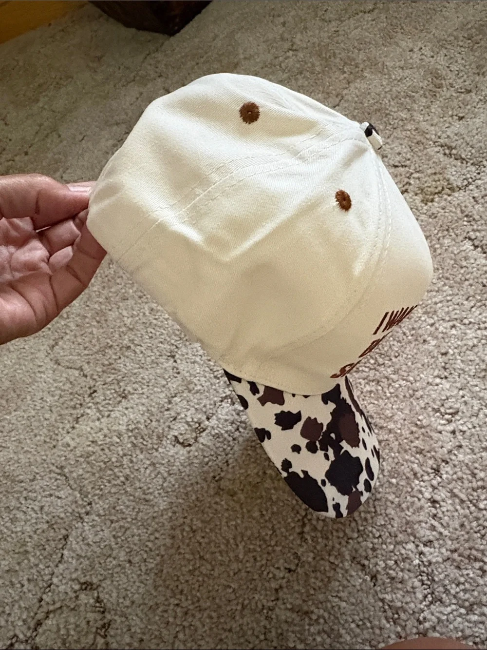 Embroiled Cream and Brown Cow Print Trucker Hat with Bold Quote
